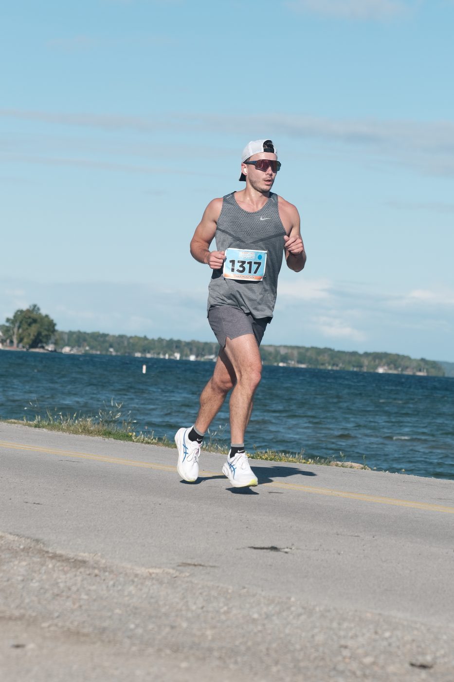 Dr. Daniel Silva running a half marathon on a lakeside road