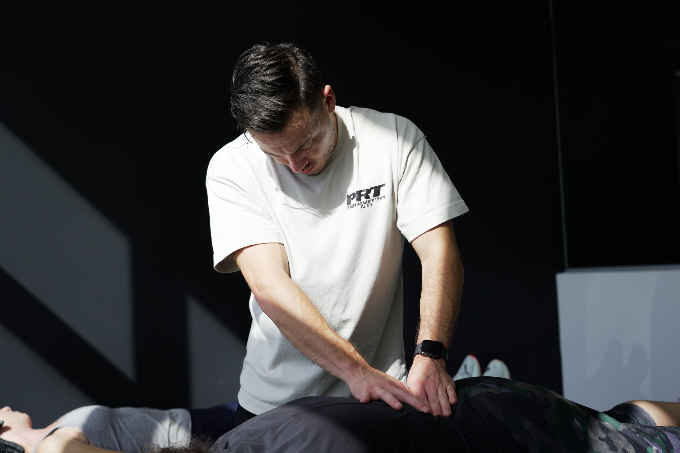 Dr. Daniel Silva, chiropractor and co-founder at PRT, delivering 1-on-1 treatment